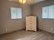 Bedroom featuring tile floors, neutral walls, and natural light from two windows at 21570 Sw Raintree St, Dunnellon, FL 34431