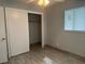 This bedroom features tile floors, a closet, and a window allowing for plenty of natural light at 21570 Sw Raintree St, Dunnellon, FL 34431