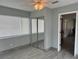This bedroom has a ceiling fan, window, wood flooring and mirrored closet at 21570 Sw Raintree St, Dunnellon, FL 34431