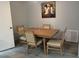 This dining room features neutral colored walls, decor, and light wood table with 4 chairs at 21570 Sw Raintree St, Dunnellon, FL 34431