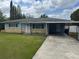 Charming single-story home with a covered carport and well-maintained front lawn at 21570 Sw Raintree St, Dunnellon, FL 34431