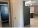 Hallway looking into updated kitchen featuring black appliances and breakfast bar seating at 21570 Sw Raintree St, Dunnellon, FL 34431