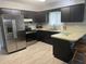 This kitchen features stainless steel appliances and dark cabinetry at 21570 Sw Raintree St, Dunnellon, FL 34431