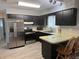 This kitchen features modern stainless steel appliances and dark cabinetry at 21570 Sw Raintree St, Dunnellon, FL 34431