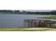 A wooden pier offers scenic lake views with seating, set against a backdrop of natural beauty at 21570 Sw Raintree St, Dunnellon, FL 34431
