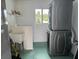 This laundry room has a sink and stackable washer and dryer at 21570 Sw Raintree St, Dunnellon, FL 34431