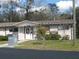 A quaint library exudes curb appeal with a welcoming entrance and well-manicured landscaping at 21570 Sw Raintree St, Dunnellon, FL 34431