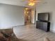 Spacious living room with wood-look tile flooring and a ceiling fan at 21570 Sw Raintree St, Dunnellon, FL 34431