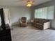 Inviting living room with tile floors, neutral paint, and comfortable furniture at 21570 Sw Raintree St, Dunnellon, FL 34431