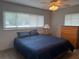 Comfortable bedroom featuring wood-look tile floors and natural light at 21570 Sw Raintree St, Dunnellon, FL 34431
