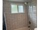 This shower features gray tile surround and updated shower head and faucet fixtures at 21570 Sw Raintree St, Dunnellon, FL 34431