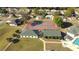 Overhead view features tennis courts and a pool house set among lush greenery and manicured lawns at 2323 Nw 55Th Avenue Rd, Ocala, FL 34482