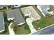 An aerial view showcasing the home's position in the neighborhood, including lawn, roof, and driveway at 2323 Nw 55Th Avenue Rd, Ocala, FL 34482