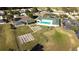 Aerial shot of community amenities, including a pool, tennis courts, bocce ball, and well-maintained grounds at 2323 Nw 55Th Avenue Rd, Ocala, FL 34482