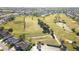 Expansive golf course views from above, surrounded by a community of beautiful single-Gathering homes and lush landscaping at 2323 Nw 55Th Avenue Rd, Ocala, FL 34482