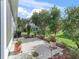 View of the backyard's concrete patio with a view of the mature landscaping at 2323 Nw 55Th Avenue Rd, Ocala, FL 34482