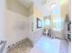 Bright bathroom featuring a tiled, no-threshold shower, grab bars, toilet, and a bathtub at 2323 Nw 55Th Avenue Rd, Ocala, FL 34482