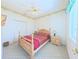 Cozy bedroom with light wood furniture, neutral carpeting, and a ceiling fan, bathed in natural light at 2323 Nw 55Th Avenue Rd, Ocala, FL 34482