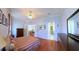 Spacious bedroom with wood floors, neutral walls, and views into the living room and bathroom at 2323 Nw 55Th Avenue Rd, Ocala, FL 34482