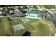 Beautiful aerial view of the community center with a pool, clubhouse, and tennis courts at 2323 Nw 55Th Avenue Rd, Ocala, FL 34482