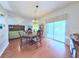 Inviting dining area with wood floors, chandelier, and sliding doors to the screened patio at 2323 Nw 55Th Avenue Rd, Ocala, FL 34482