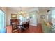 Formal dining room with a chandelier, hardwood floors, and views of the kitchen and living areas at 2323 Nw 55Th Avenue Rd, Ocala, FL 34482