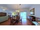 Charming dining space featuring hardwood floors, a chandelier, and a seamless connection to the living area at 2323 Nw 55Th Avenue Rd, Ocala, FL 34482