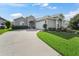Charming home featuring a well-maintained lawn, a driveway, and lovely landscaping at 2323 Nw 55Th Avenue Rd, Ocala, FL 34482