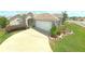 Charming single-story home featuring a driveway, attached garage, and manicured landscaping at 2323 Nw 55Th Avenue Rd, Ocala, FL 34482
