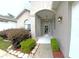 Inviting front entrance featuring a tiled entryway, decorative lighting, and well-maintained landscaping at 2323 Nw 55Th Avenue Rd, Ocala, FL 34482