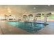 Picture of a well-lit indoor pool with vaulted ceilings and glass doors offering a relaxing swimming experience at 2323 Nw 55Th Avenue Rd, Ocala, FL 34482