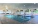 Lovely indoor community pool and vaulted ceiling with sliding glass doors and ample seating and space at 2323 Nw 55Th Avenue Rd, Ocala, FL 34482