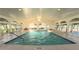 Picture of a well-lit indoor pool with vaulted ceilings and glass doors, offering a relaxing swimming experience at 2323 Nw 55Th Avenue Rd, Ocala, FL 34482