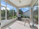 Enclosed lanai offering scenic views of the backyard and equipped with an outdoor grill and seating at 2323 Nw 55Th Avenue Rd, Ocala, FL 34482
