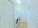 Functional laundry area with washer, dryer, storage shelves and direct access to outdoors at 2323 Nw 55Th Avenue Rd, Ocala, FL 34482