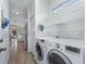 Convenient laundry room with modern appliances, shelving and access to kitchen at 2323 Nw 55Th Avenue Rd, Ocala, FL 34482