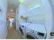 Featuring tile flooring, LG washer and dryer, and built in wire shelving in this laundry room at 2323 Nw 55Th Avenue Rd, Ocala, FL 34482