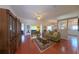 Spacious living room showcasing hardwood floors, comfortable seating, and seamless flow to the dining area at 2323 Nw 55Th Avenue Rd, Ocala, FL 34482