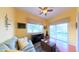 Relaxing living room with a comfortable couch, natural light, and a sliding glass door leading to the porch at 2323 Nw 55Th Avenue Rd, Ocala, FL 34482