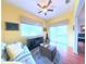 Cozy yellow living room with comfortable seating, sliding glass doors and area rug at 2323 Nw 55Th Avenue Rd, Ocala, FL 34482