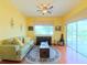 Cozy living room with hardwood floors, natural light, and a comfortable seating area with a sliding glass door at 2323 Nw 55Th Avenue Rd, Ocala, FL 34482