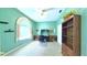 Spacious office with mint colored walls, a large window, a ceiling fan, and ample built-in storage at 2323 Nw 55Th Avenue Rd, Ocala, FL 34482