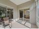 Covered back porch with furniture. Glass doors lead into the interior living spaces at 2323 Nw 55Th Avenue Rd, Ocala, FL 34482