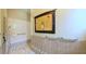 Tiled walk-in shower with safety bars and beautiful accents throughout the bathroom at 2323 Nw 55Th Avenue Rd, Ocala, FL 34482