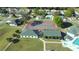 Aerial view showcasing community tennis courts beside clubhouse, surrounded by well-maintained landscaping and neighborhood homes at 2323 Nw 55Th Avenue Rd, Ocala, FL 34482