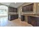 Spacious kitchen featuring elegant dark wood cabinetry and light-colored countertops at 23962 Nw Shamrock Ave, Dunnellon, FL 34431