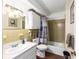 Cozy bathroom with a single sink vanity, tiled walls, framed mirror, and shower-tub combination with curtain at 2433 Ne 7Th St # 3, Ocala, FL 34470