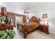 Comfortable bedroom boasts traditional wood furniture, carpet flooring, ceiling fan, and a window for natural light at 2433 Ne 7Th St # 3, Ocala, FL 34470