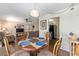 Open dining area with hardwood floors, a decorative table setting, and views into the living room and kitchen at 2433 Ne 7Th St # 3, Ocala, FL 34470