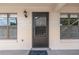 Inviting front door entrance with sidelight windows and exterior lantern lighting fixture at 2433 Ne 7Th St # 3, Ocala, FL 34470